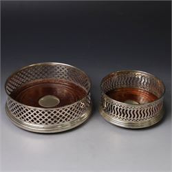 Two silver mounted bottle coasters, the larger example with latticework sides, hallmarked ...