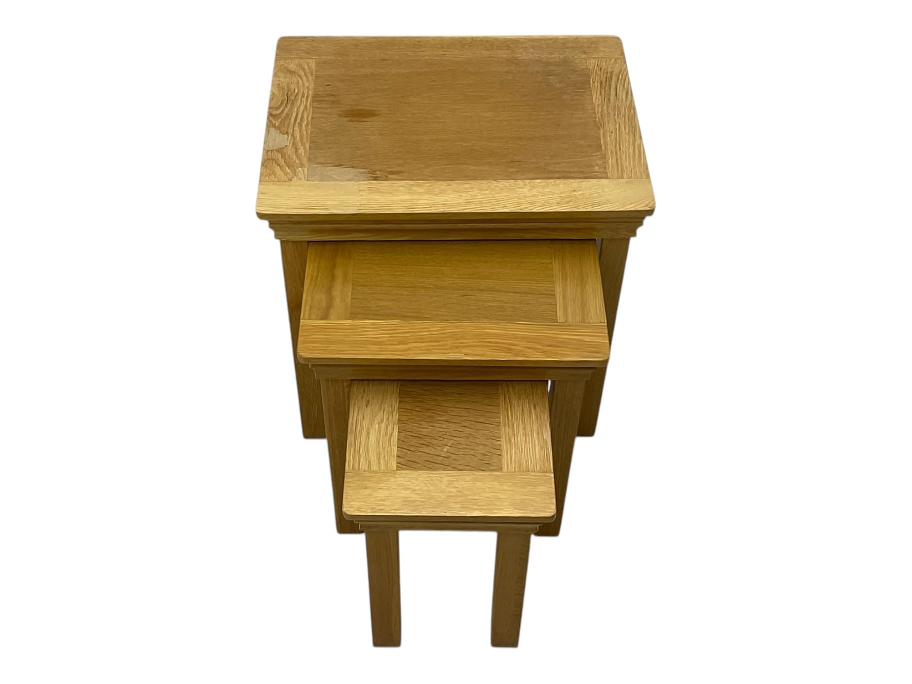 Contemporary light oak nest of three tables, each with rectangular top with moulded edge, raised on square supports