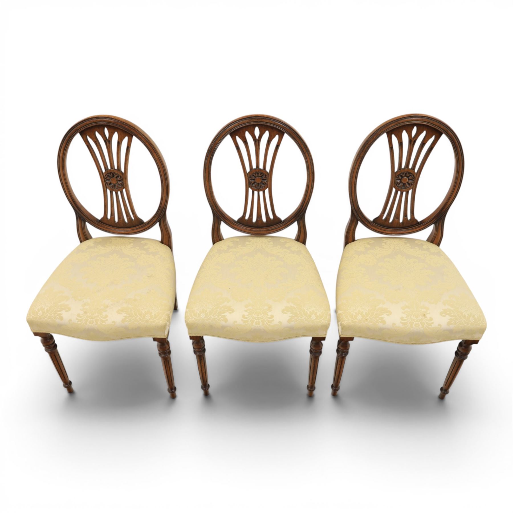 Bevan Funnell Reprodux - Regency design set of ten mahogany dining chairs, oval backs with central splat with rose motif, serpentine seat upholstered in damask fabric, raised on turned supports