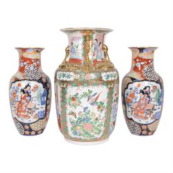Pair of Japaneses imari vases, the central panel, decorated with figures in a landscape, t...