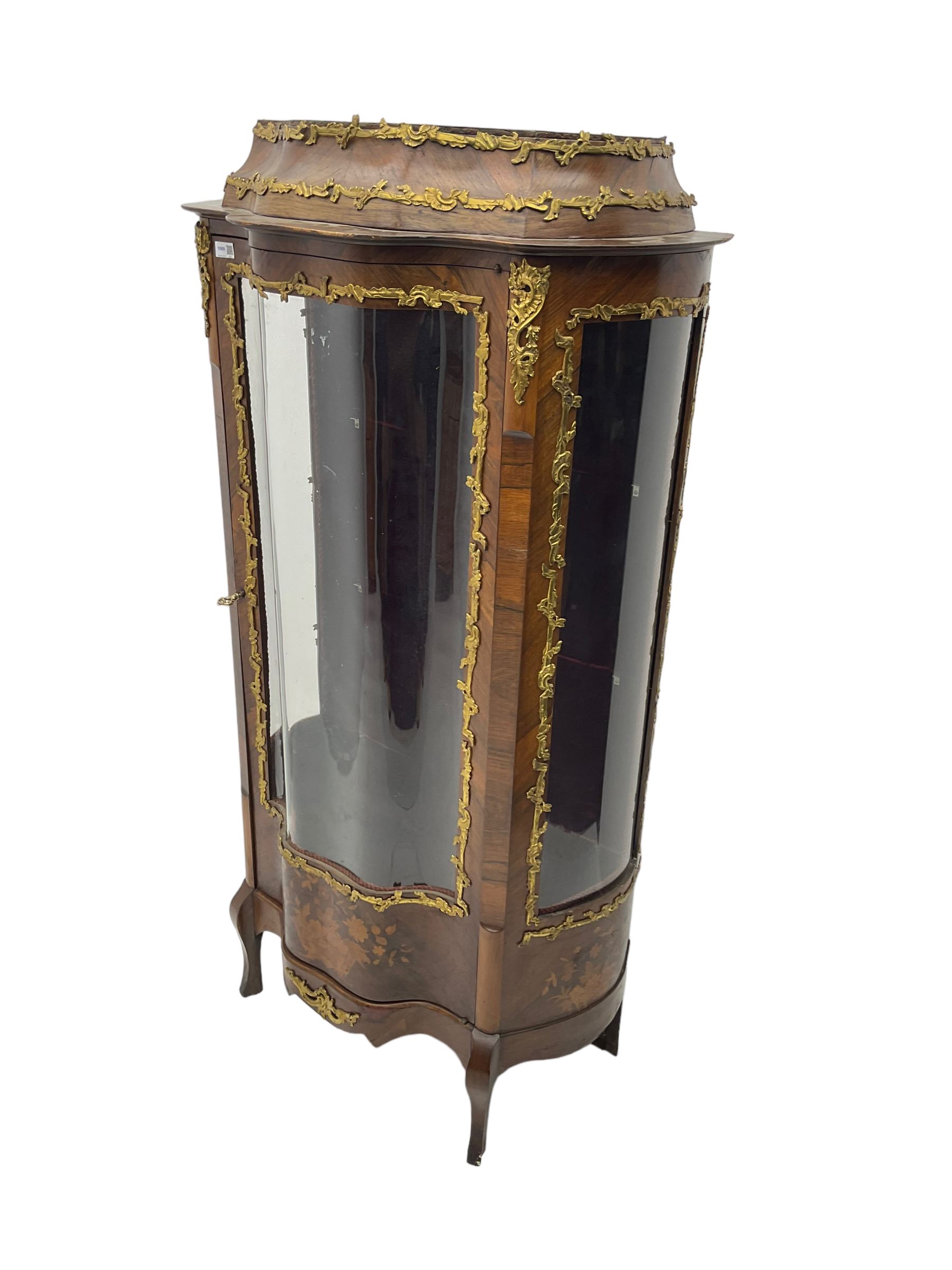 Early 20th century French kingwood vitrine or display cabinet, decorated with applied foliate cast band, serpentine glazed door and sides, inlaid with marquetry decoration of floral bouquets and branches, cartouche mounts to the apron, raised on cabriole supports
