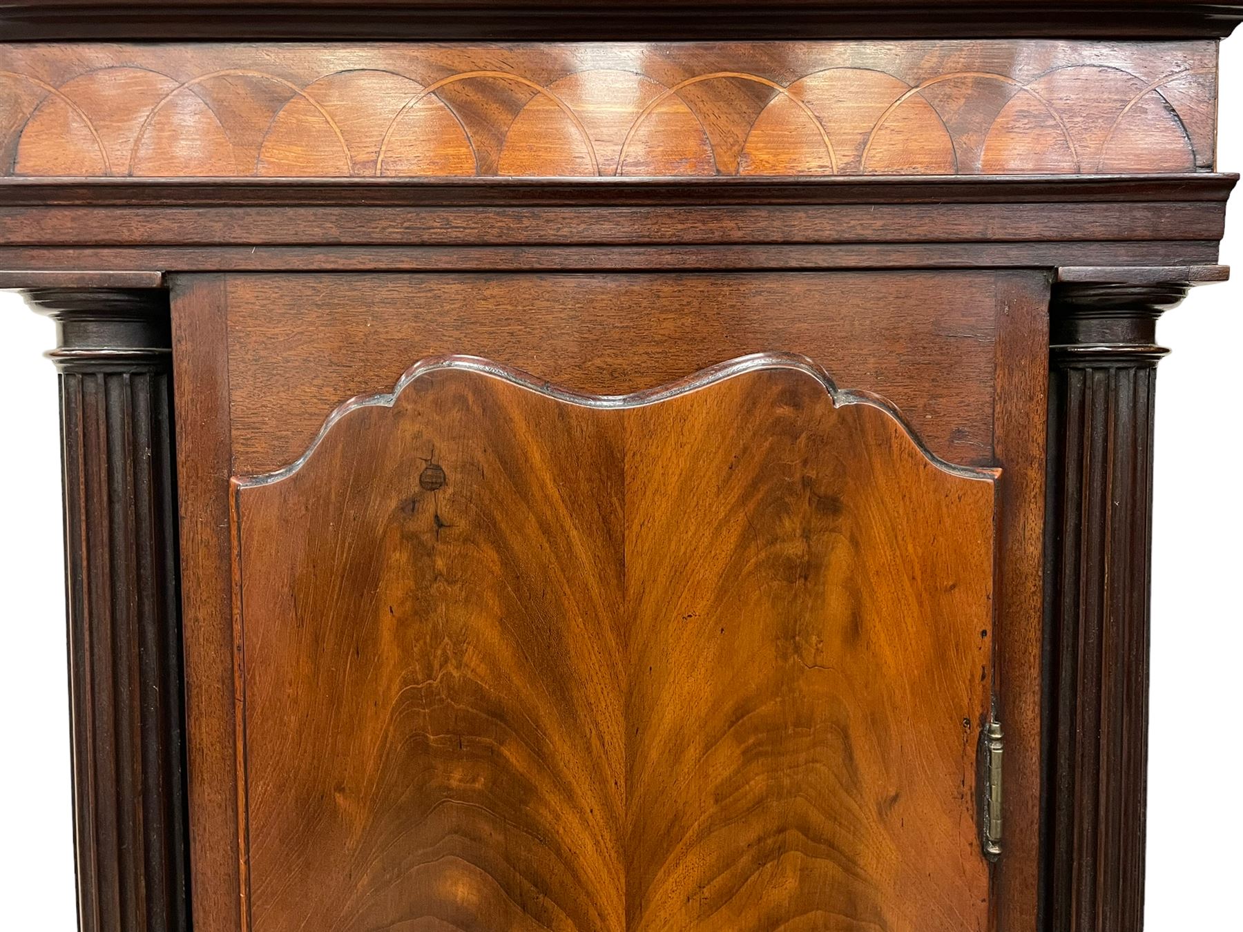 Penlington of Liverpool – early 19th century 8-day mahogany longcase clock, swans neck pediment with three turned wooden finials and verre eglomise panels, trunk with reeded columns and wavy topped door, plinth with canted corners on bracket feet, painted break-arch dial with Roman numerals and five-minute Arabic’s, centre sweep calendar and seconds hands, blue steel serpentine hands, signed beneath a painted rolling moon in the arch PENLINGTON, LIVERPOOL, eight day four pillar movement, anchor escapement and rack striking on a bell. With pendulum and weights.  The Penlington family were prolific clockmakers in 19th century Liverpool working from several addresses in the city, also recorded as chronometer and chronograph makers.