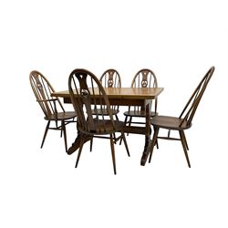 Ercol - elm and beech 'draw-leaf' extending dining table (W114cm D79cm H75cm); and Ercol - set five (4+1) quaker 'Swan' back dining chairs (W50cm D60cm H101cm)