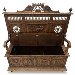 19th century European heavily carved oak hall settle, the impressive high-back with a pierced and carved acanthus pediment, over foliate and rosette carved back rails, flanking a central panel depicting a gentleman on horseback drinking, the hinged box seat over a quadruple panelled front with relief carved busts, lower moulded and carved edge on compressed bun feet