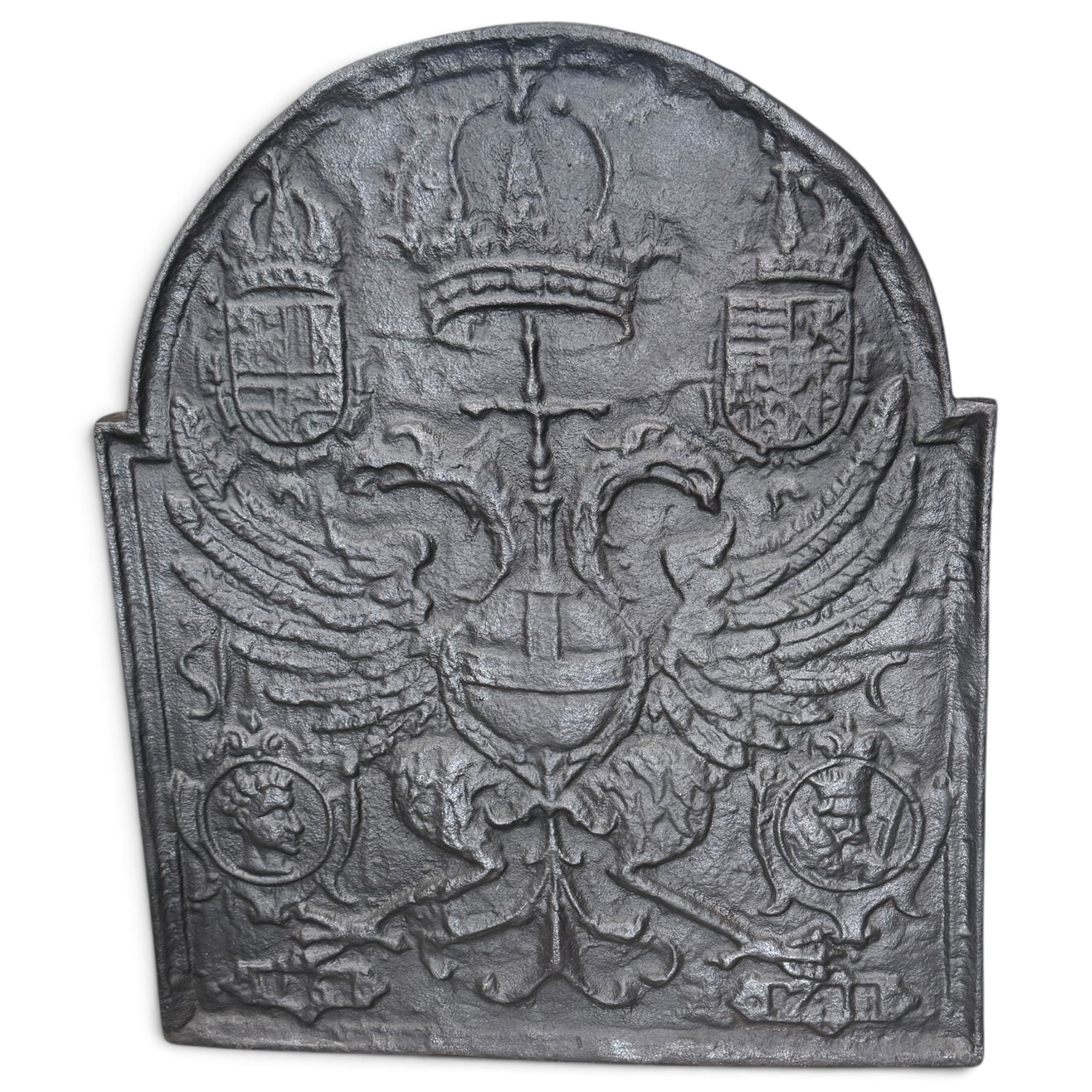 Early 20th century cast iron fireback, after an 18th century Flemish original, the arched plate cast in relief with the crowned Habsburg double-headed Imperial eagle and armorial shields of Charles V, Holy Roman Emperor
