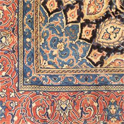 Large North West Persian Mahal hand-knotted carpet, central indigo field with a rosette medallion with an all-over design of scrolling vines and palmettes, framed by a brick red border of arabesques and flowerheads between sky blue and ivory guard stripes, with cotton fringe ends 