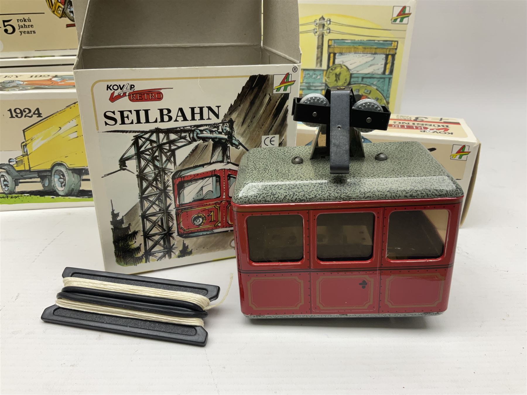Kovap - eleven tinplate models to include Tractor and Trailer, Road Roller 1927, Moving Moneybox 1924, Hawkeye type B 1924, Boy on a Tricycle; all in original boxes 