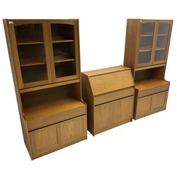 Sutcliffe of Todmorden - pair of teak wall units, fitted with two glazed doors over drawer and double cupboard (W86cm, D45cm, H198cm); and a matching fall front bureau (W84cm, D41cm, H100cm)