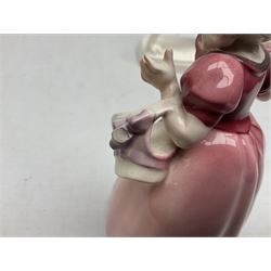 Early 20th century Katzhütte figure of a pointer dog, and figure of a young girl holding basket and fan, both with green cat H house printed mark beneath, dog L25cm