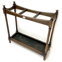 Edwardian three section oak stick stand, turned supports joined by undertier with metal tray