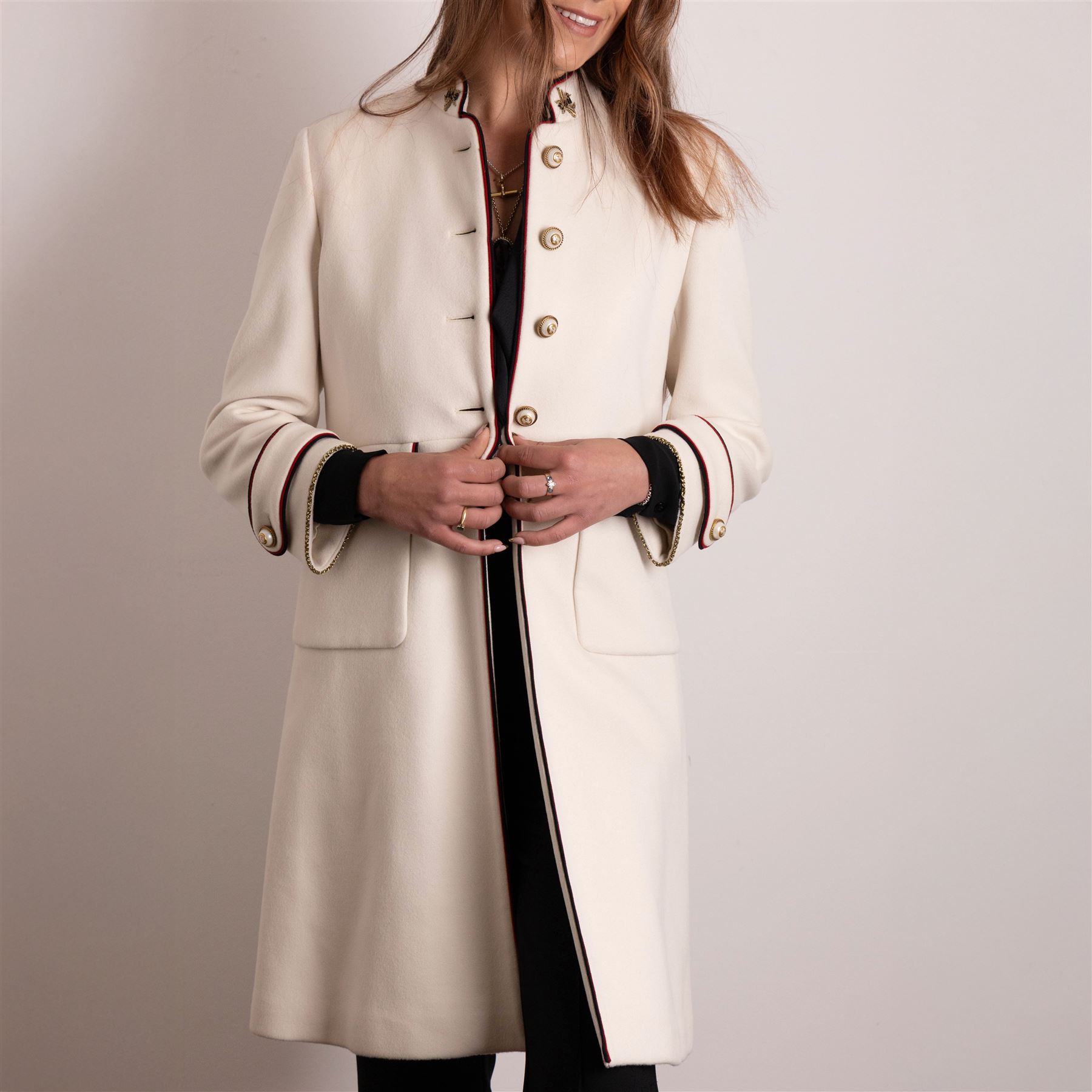 Gucci - bee embroidered wool single-breasted military coat, from the Autumn/Winter 2017 collection under Alessandro Michele, in ivory, with stand collar, red and navy trim, pearlescent and gold-tone button fastening and embroidered bee detailing to the collar, size 14, unused with original garment bag and tags