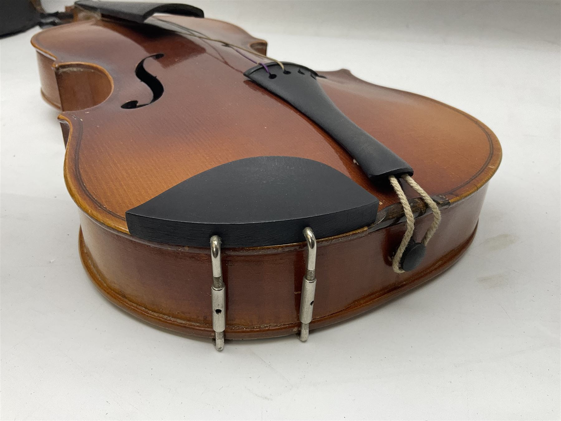 Czechoslovakian violin c1920 with 36cm two-piece maple back and ribs and spruce top, bears label 'Copy of Antonius Stradivarius Made in Czechoslovakia' L59cm; in carrying case; 1950s Czechoslovakian violin; and 195os Czechoslovakian three-quarter size violin; both cased (3)