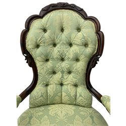 Victorian walnut farmed open armchair, the cresting rail relief carved with scrolls and central cartouche, upholstered seat and arms, with buttoned back in pale green foliate pattern fabric, cabriole supports