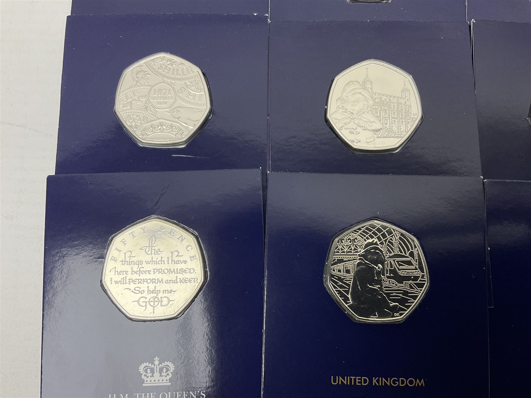 Mostly United Kingdom Queen Elizabeth II commemorative fifty pence coins, including 2019 'Gruffalo', 2020 'Iguanodon', 2022 'The Queen's Jubilee' etc, housed on cards, face value of UK coins approximately 20 GBP