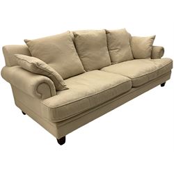 Grande four seat sofa, upholstered in natural linen, shaped back, scroll arms