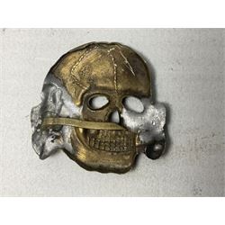 Two WW2 German 'SS' visor cap skull badges and another later; and visor cap eagle insignia (4)