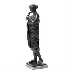 After the Antique - Grand Tour patinated bronze figure of a Vestal Virgin, the maiden standing in contrapposto, draped in classical robes and pinning her chiton at the shoulder and chest, on a square marble base stamped to rear, circa 1900, W15cm H47cm