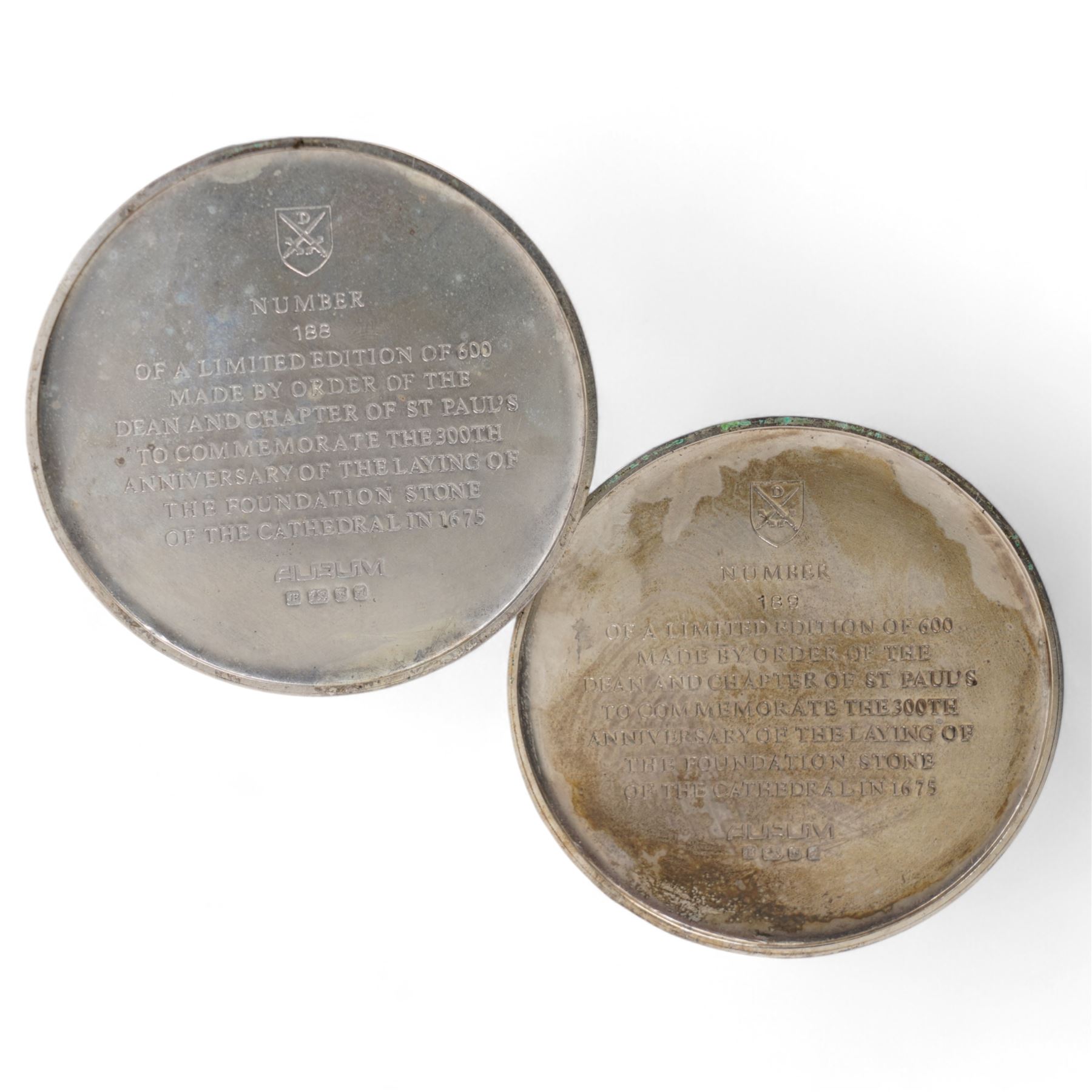 St Paul's Cathedral limited edition silver goblets, commemorating the 300th anniversary of the laying of the foundation stone of the cathedral in 1675, designed by Jocelyn Burton for Aurum, the gilt stems sculpted as phoenixes with outstretched wings supporting the bowl, the pedestals inscribed 'Resurgam', with gilded interiors, no. 188 and 189/600, hallmarked Jocelyn Burton, London 1975, H16cm, with certificates and original case