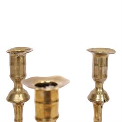 pair of 18th century brass candlesticks, each having slender knopped stems and scalloped petal base, together with two other brass candlesticks, H21cm