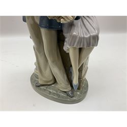 Lladro figure, Sailors Serenade, modelled as a sailor playing an accordion with a woman seated upon a crate, no 5276, year issued 1985, year retired 1988, H32cm