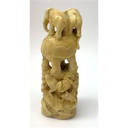 Early 20th century Japanese carved ivory okimono, modelled as a tower, the lower section modelled as frogs or toads, leading to an elephant supporting two smaller, H10cm.