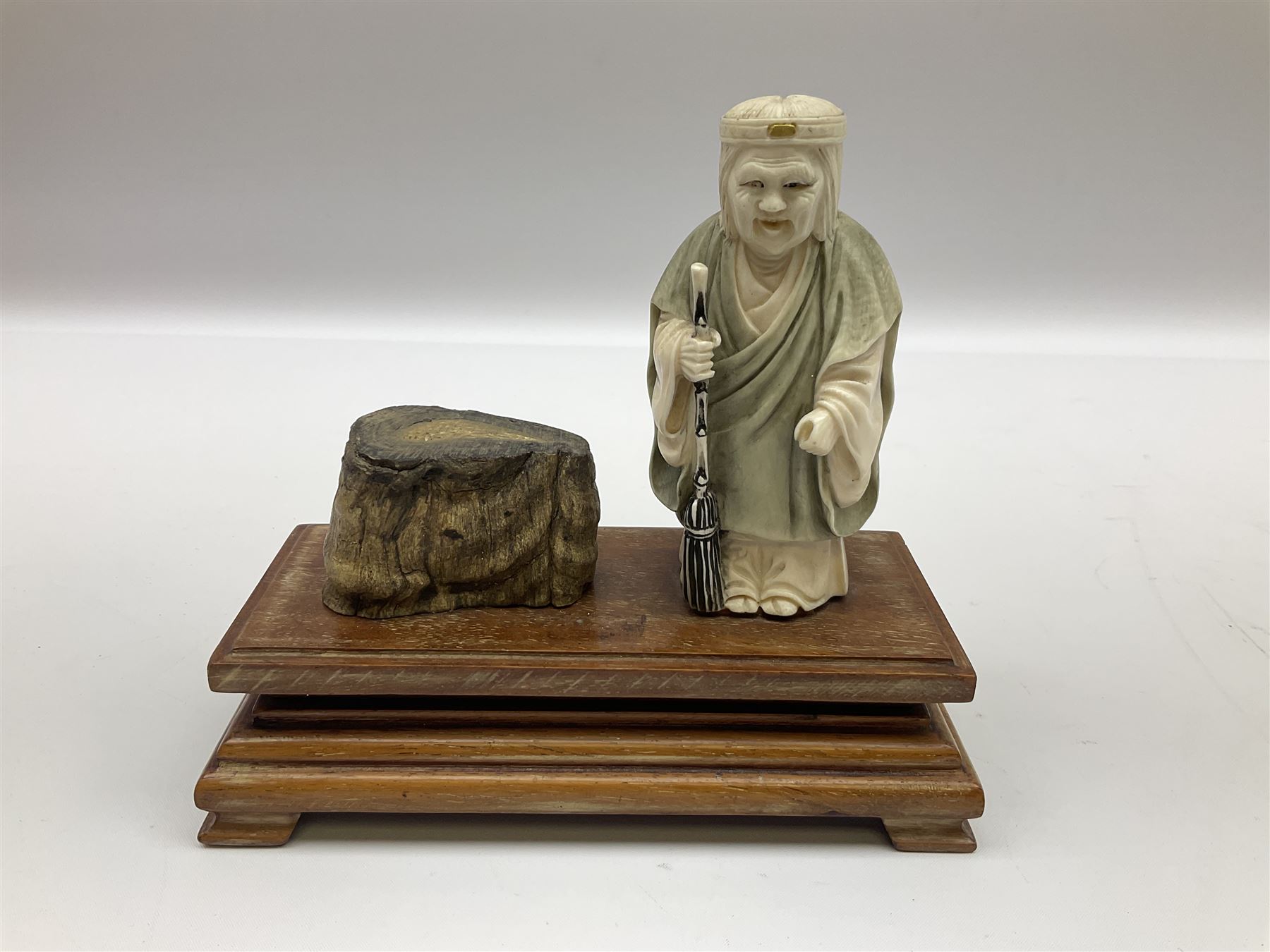 Japanese parquetry puzzle box L12cm; another Japanese puzzle box with marquetry top of Mount Fuji; eleven graduated Chinese figures including immortals; and Chinese figure of a lady standing on a hardwood base next to a horn table (14)