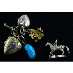  9ct gold horse on plinth, nugget, lockets and kidney bean charms  
