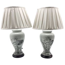 Pair of Chinese porcelain table lamps, each of inverted baluster form, decorated with wading Herons amongst reeds against a plain ground, raised upon circular hardwood base, H66cm including shade 