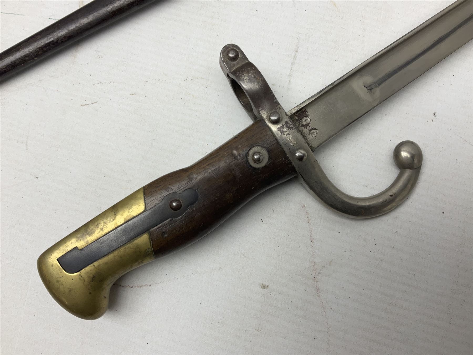 French Model 1866 Chassepot bayonet with 57cm curving fullered steel blade dated 1873 No.L63963; in steel scabbard with conforming number L71.5cm overall; and French St. Etienne Gras bayonet dated 1878 No.K10674 in steel scabbard numbered 79437 (2)