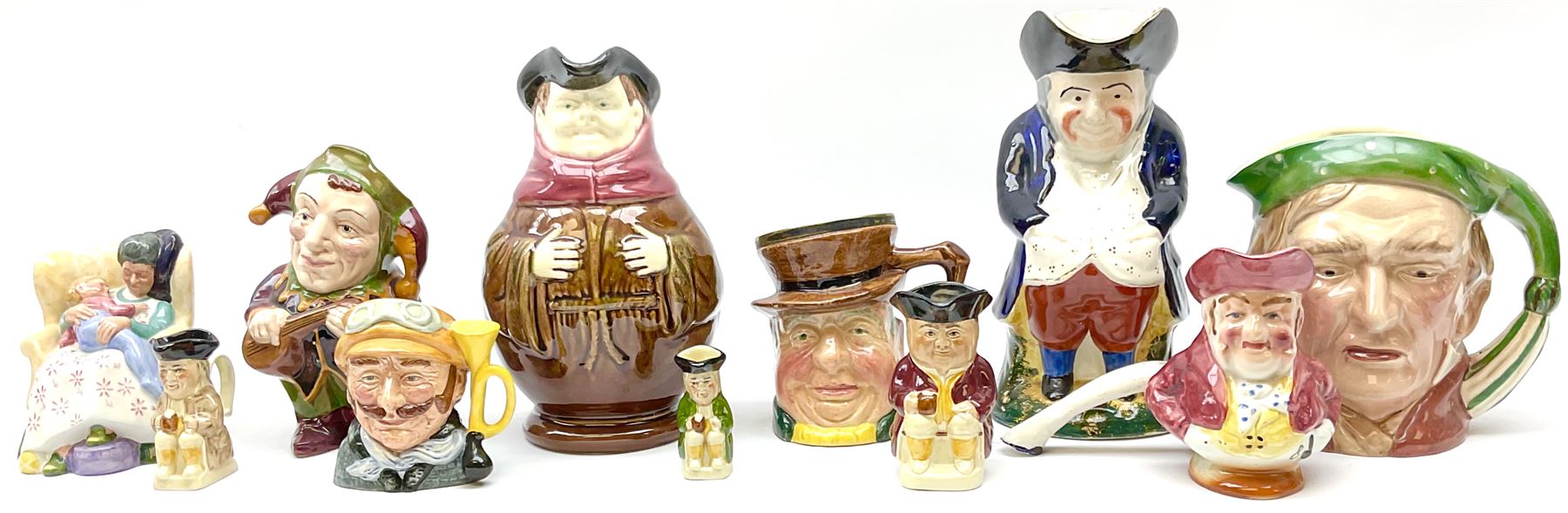 Character and toby jugs, including a staffordshire pottery style toby jug, Olfaire toby jug, Beswick character jug depicting Scrooge, Royal Doulton Veteral Motorist etc, together with Royal Doulton Sweet Dreams figure. 