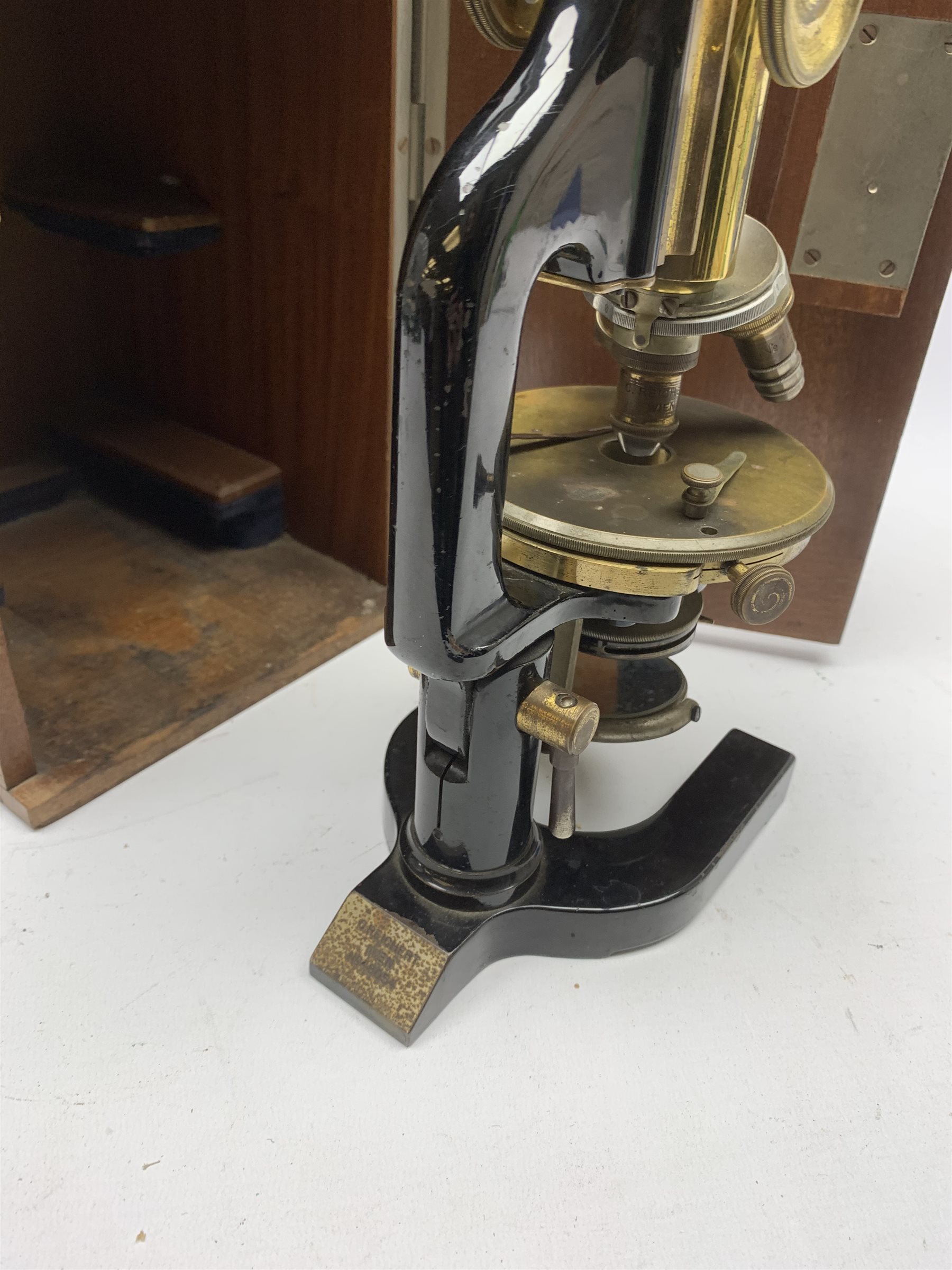  Reichert Wien Late 19th century brass and black japanned monocular microscope stamped C.Reichert Wien, No.48054, coarse and fine adjust, circular stage on horseshoe base, with three ocular and five objective lenses, in fitted mahogany case   
