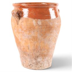 Spanish terracotta twin handled olive jar, of typical baluster form with orange glaze decoration, H34cm