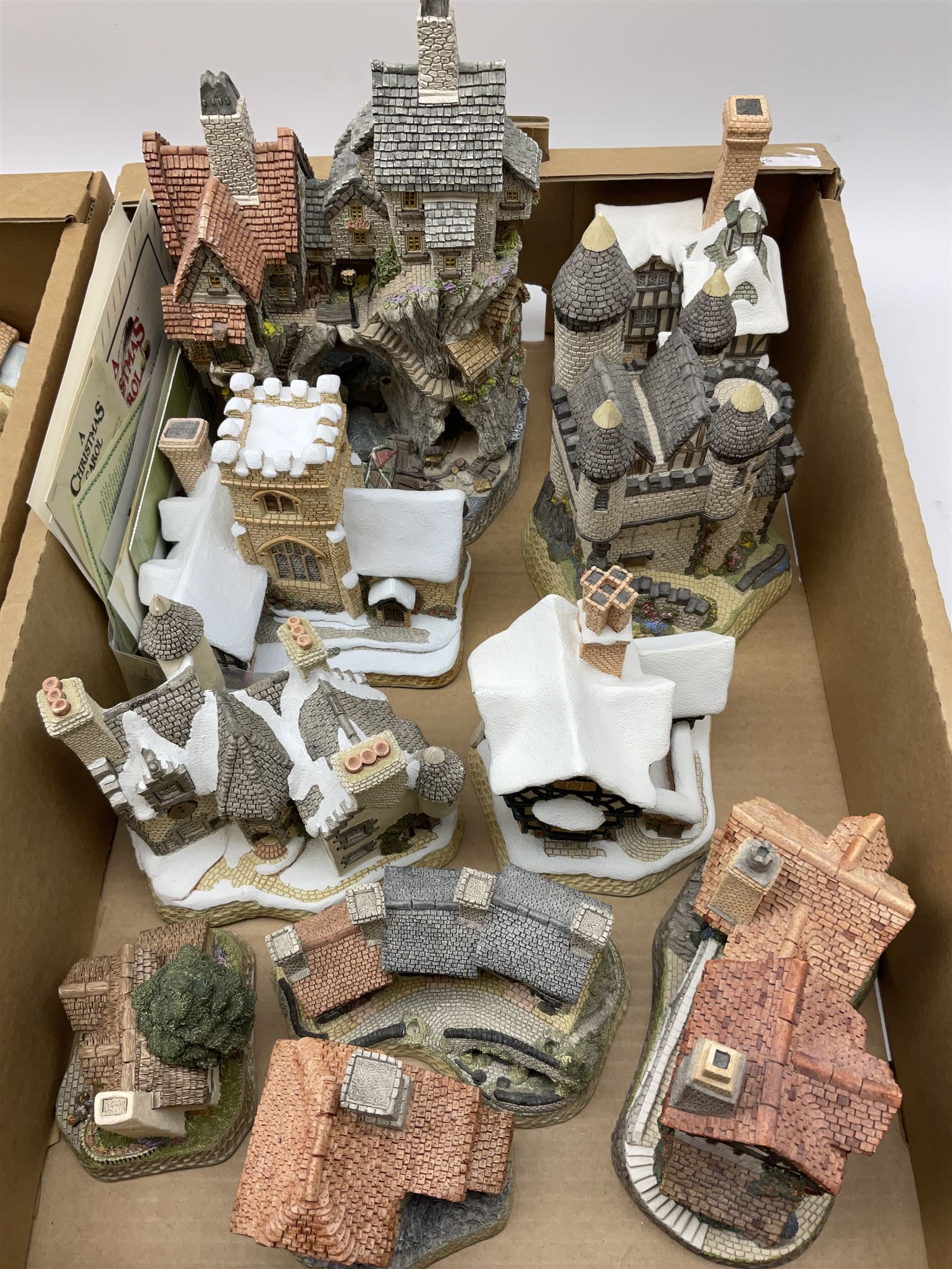 A collection of boxed David Winter cottages, of various size and form, to include Wreckers Cottage, Scottish Collection Macbeth's Castle, Special for Christmas 1988 Christmas in Scotland and Hogmanay, Special for Christmas 1990 Mister Fezziwig's Emporium, The Scrooge Family Home, Special for Christmas 1989 A Christmas Carol, The Midlands Collection Miners Row, Will-o-the wisp, etc., together with a plaque titled On the Riverbank, a number of examples with accompanying certificates. (30).