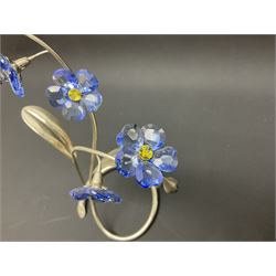 Eleven Swarovski Crystal flowers, to include violet, sunflower, delphinium, forget-me-not and lily-of-the-valley, each on stylised metal stems, tallest H23cm