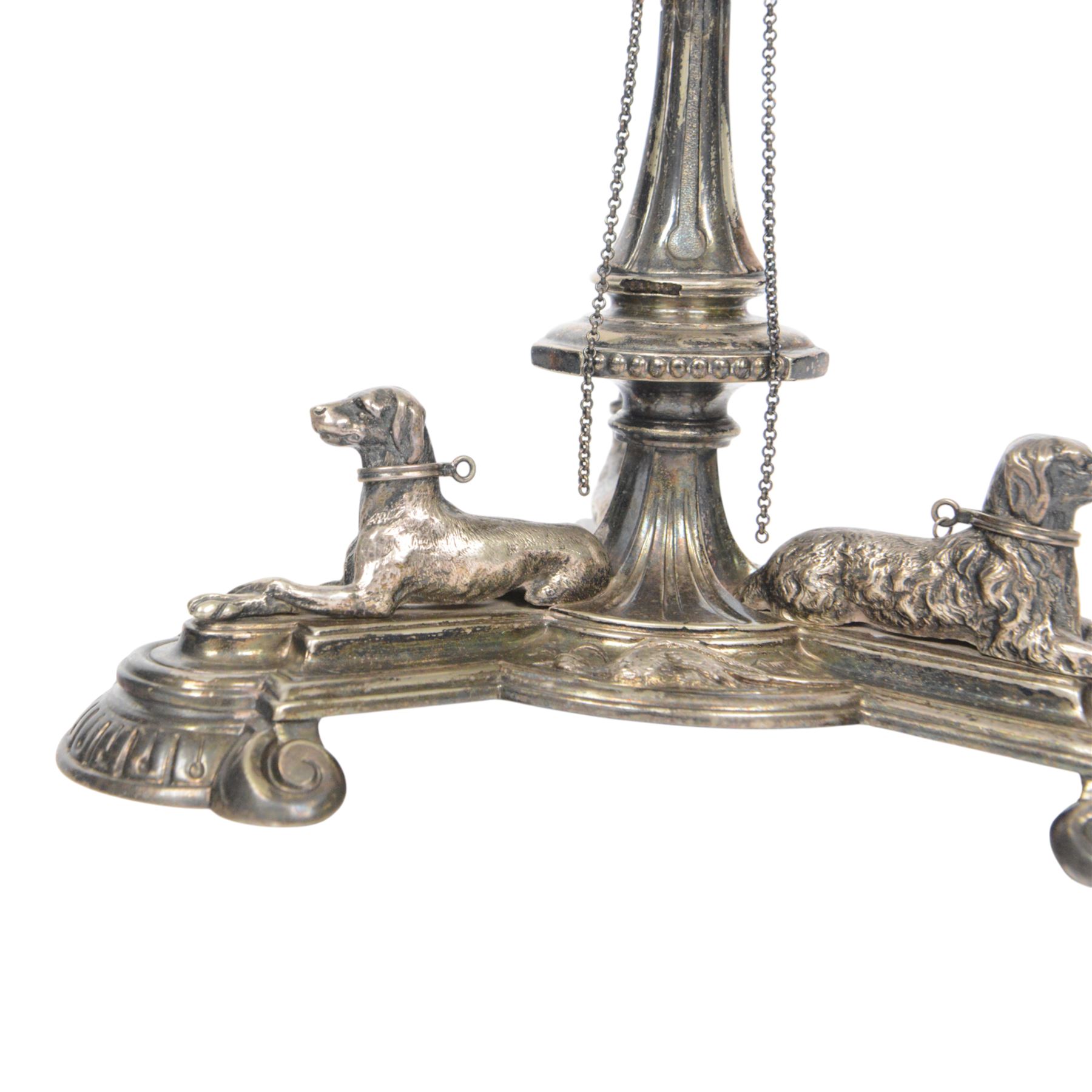 Edwardian silver plated centrepiece stand, the tripart base with applied recumbent hunting dogs interspersed with fox masks and game birds, the central knopped and tapering stem leading to a circular stand, marked 3251 beneath, H22cm  