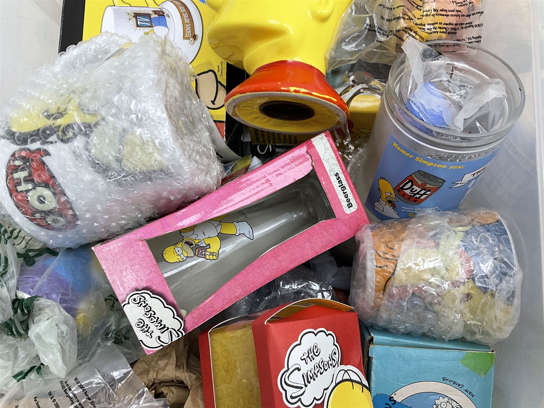 Large quantity of The Simpsons merchandise and memorabilia, to include Micro Scalextric, mugs, jigsaw, bottle openers, solar pal, glasses, etc, many boxed
