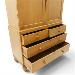 Victorian stripped pine housekeepers cupboard, projecting cornice over two panelled cupboard doors enclosing two shelves, the base fitted with two short over two long graduating drawers, lower moulded edge over turned feet