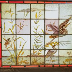 Large Victorian Aesthetic movement stained glass leadlight window panel, hand painted with a scene of herons and other birds in a lake, overall 82cm x 147cm 