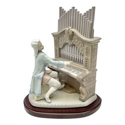 Lladro figure, Young Bach, modelled as a young Johann Sebastian Bach playing the piano, on a mahogany oval base, limited edition 2348/2500, in original box, no 1801, year issued 1994, year retired 1995, H29cm