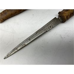 Near pair of African Moroccan Berber tribal Shula daggers each with engraved 39cm curving fullered steel blade, carved and inlaid horn grip and leather covered scabbard L57cm overall; kindjal style dagger with brass covered and jewelled grip and scabbard; another Eastern dagger with leather covered grip and scabbard; and a large Eastern knife with animal hide scabbard (5)