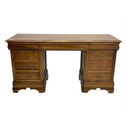 French cherry wood kneehole desk or dressing table, moulded rectangular top over twin pedestal bases each housing three drawers with brass-effect swing handles, resting on bracket feet