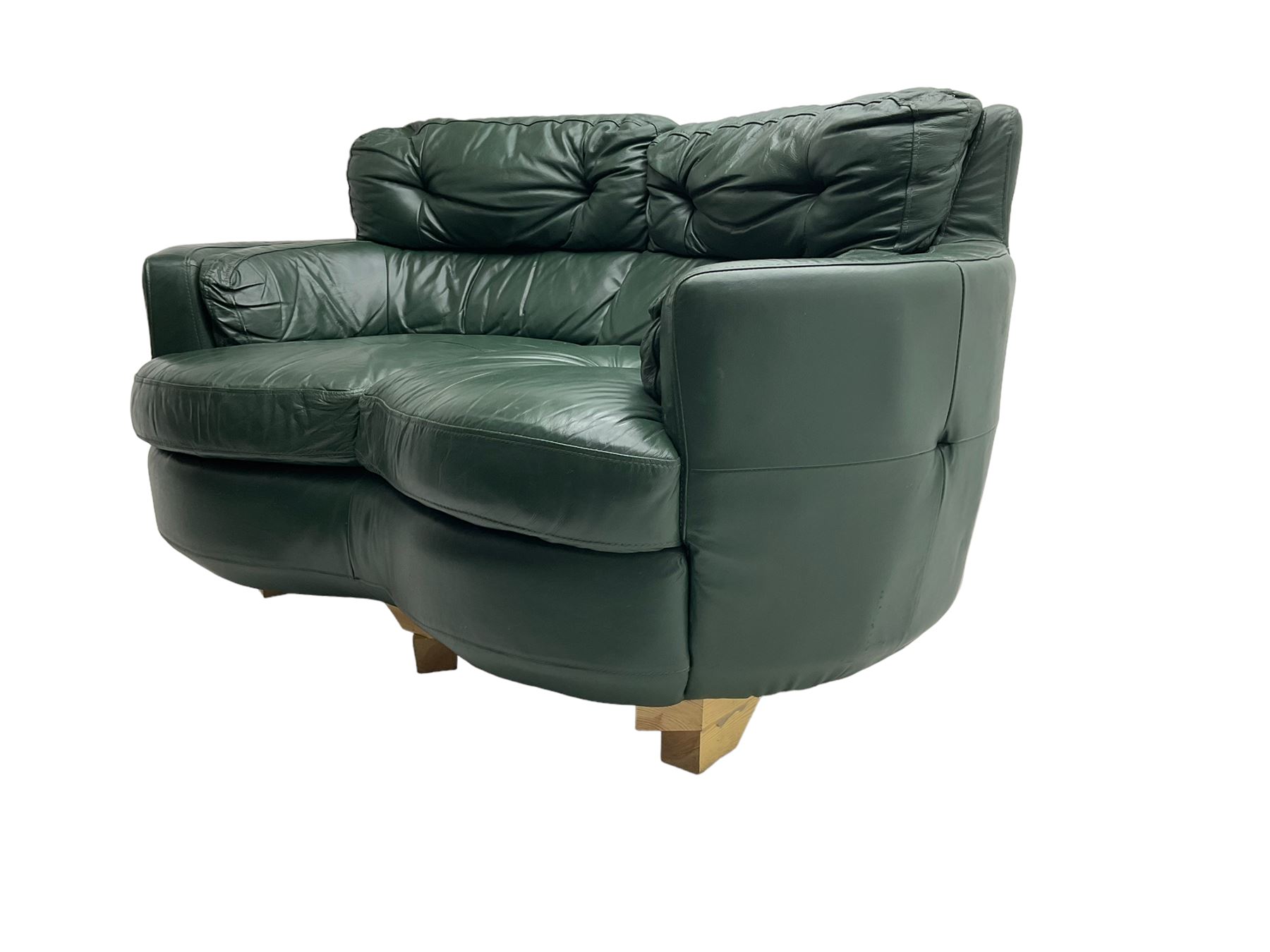 Two seat serpentine sofa, upholstered in green buttoned leather