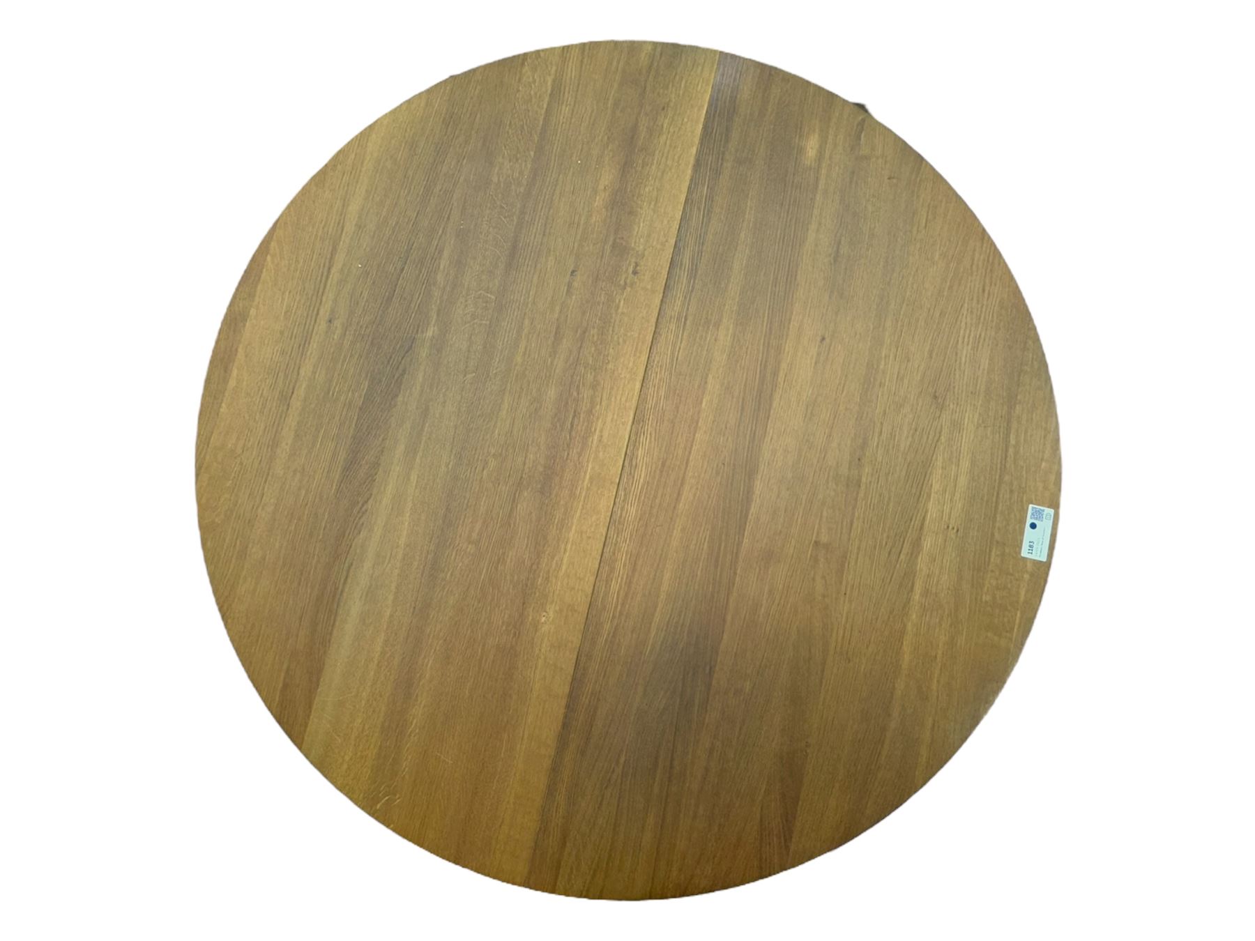Contemporary light oak round extending dining table with four chairs, table has fold out leaf attached underneath on four out-swept legs, Oak chairs with straight top rail over twin slat back with pierced motifs, brown leather seat with brass studs, square legs joined by plain stretcher 