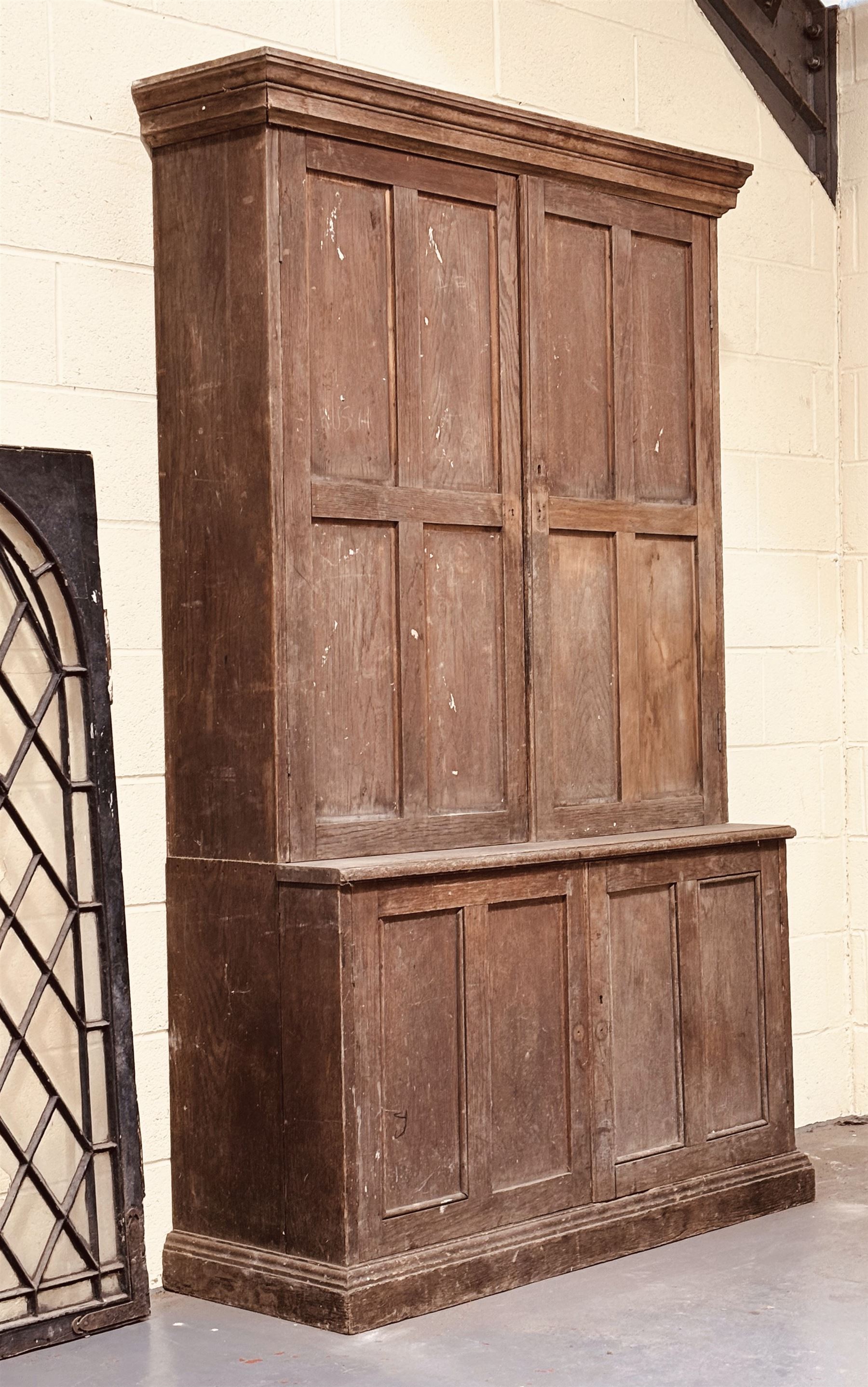 Late Victorian oak cupboard, the moulded cornice above two panelled doors, each enclosing three shelves, the base with two further doors opening to shelves behind. H214cm, W130cm, D48cm. - COLLECTION BY APPOINTMENT FROM: The White House, Thirsk Road, Easingwold, York, YO61 3NF - CALL 01723 507111 TO ARRANGE