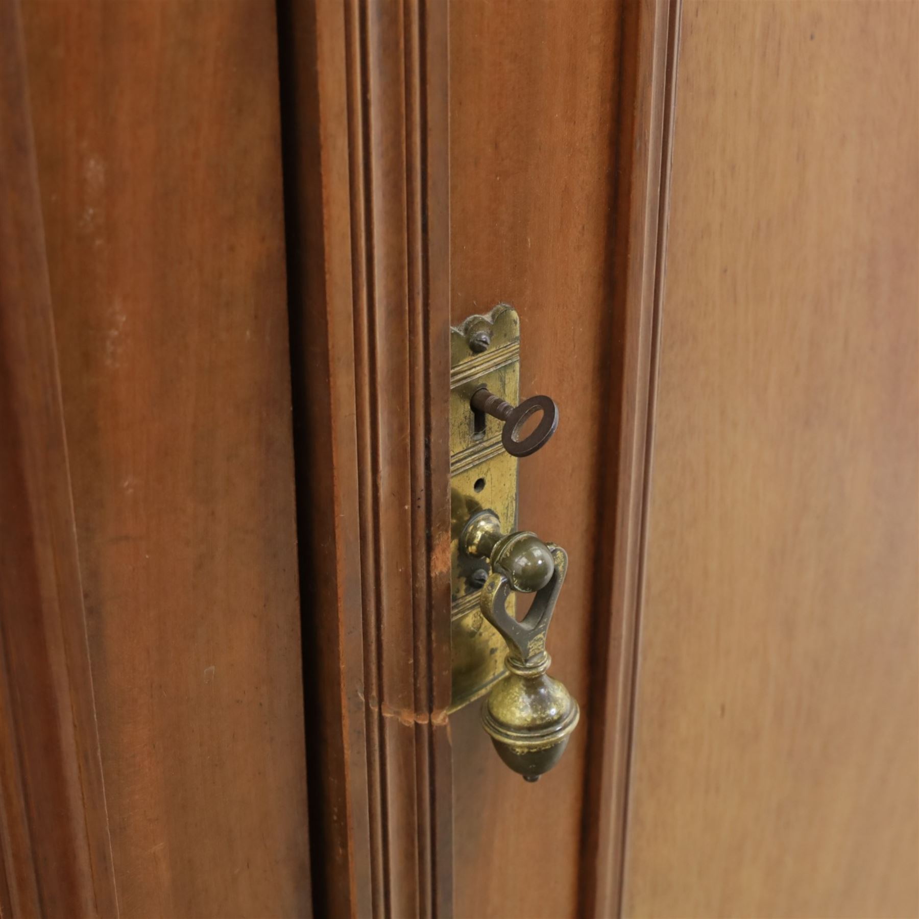 Edwardian walnut double wardrobe, fitted with two panelled doors, opening to reveal fitted interior with hanging space, three sliding linen trays and three drawers