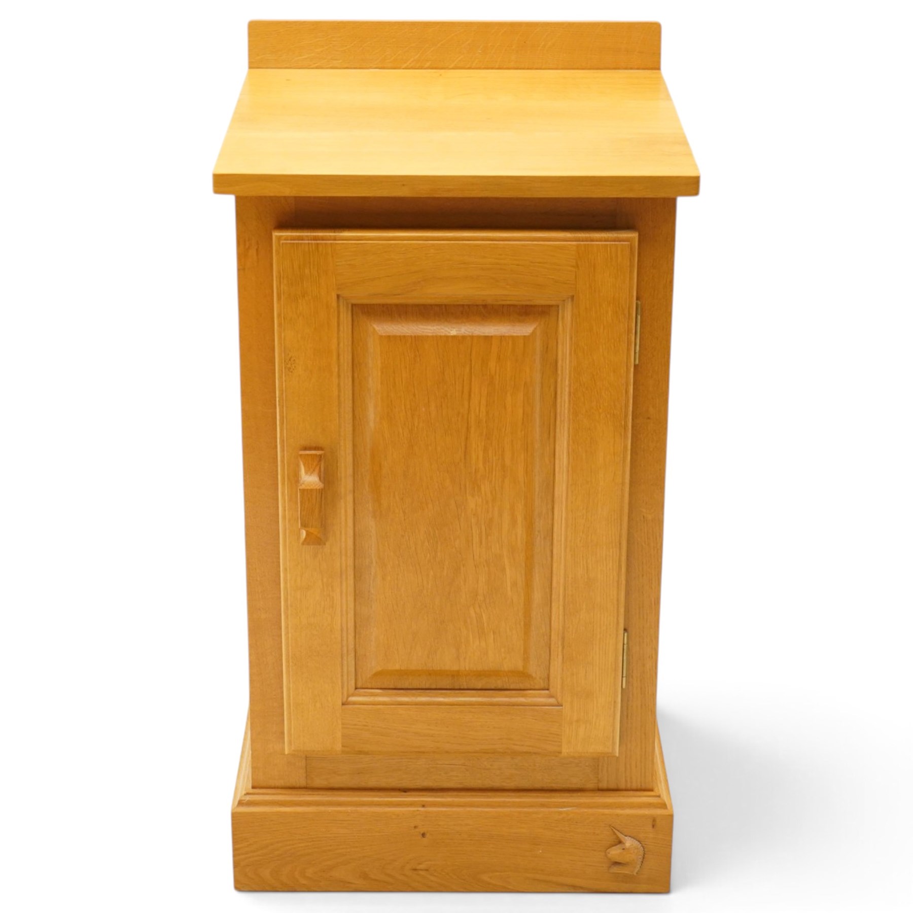 Unicornman - craftsman made oak bedside cupboard, raised back over panelled cupboard, on skirted base applied with carved unicorn signature, by Geoff Gell of Coxwold