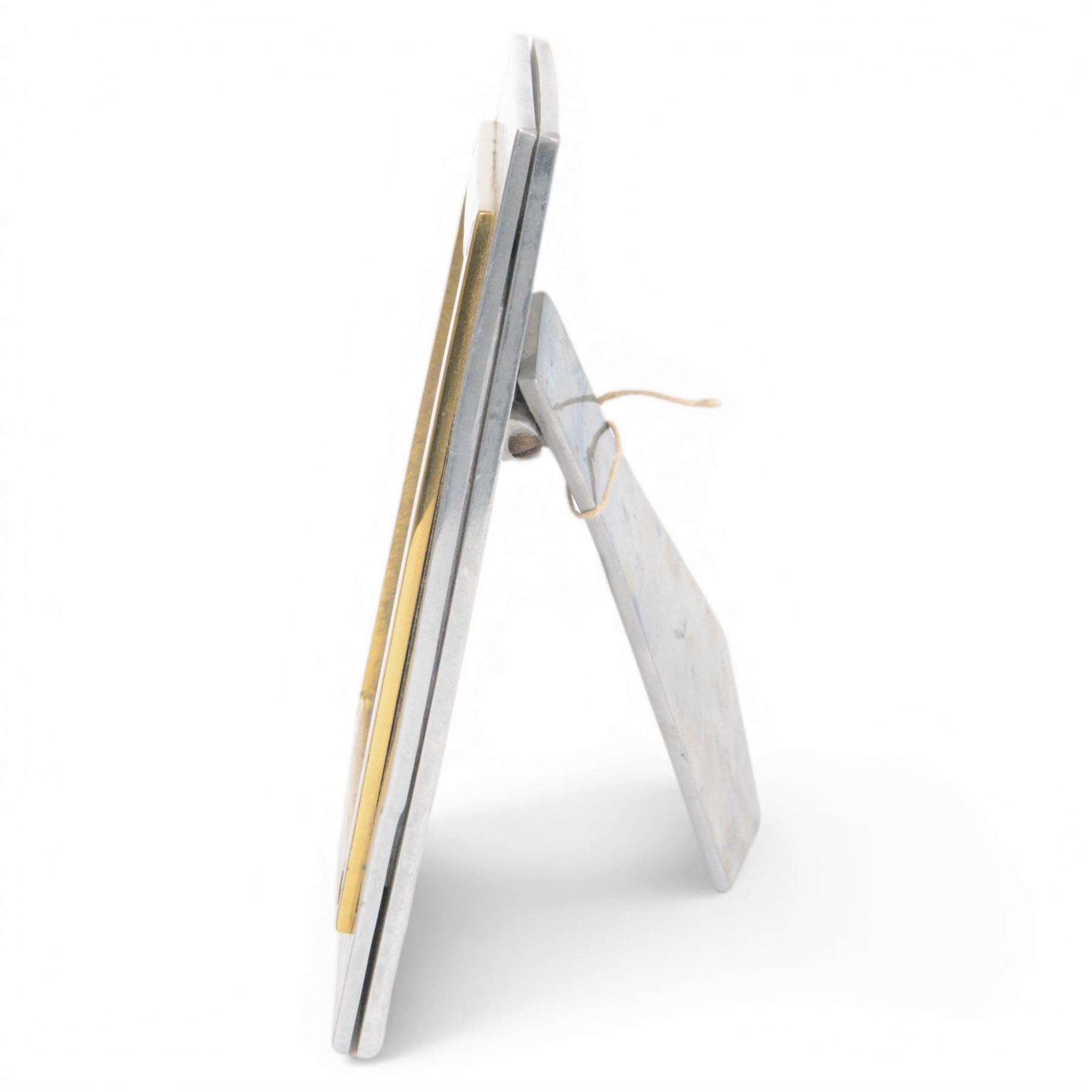 David Marshall photo frame, of cast aluminium mounted with a smaller brass frame, the maker's mark impressed to the lower left hand corner, H23cm