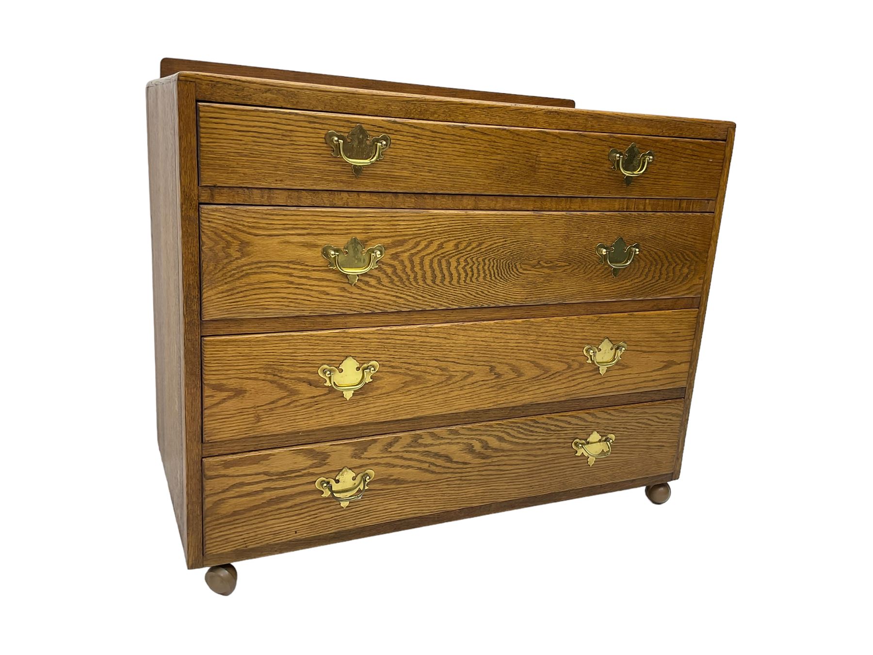 Mid-20th century oak chest, raised back, fitted with four graduating drawers, on castors