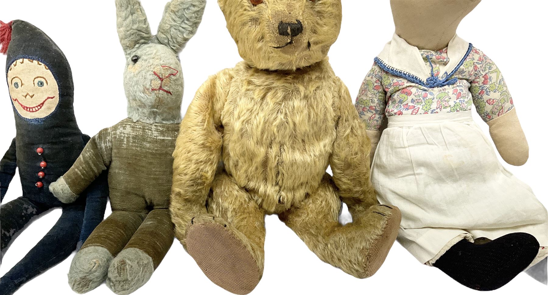 1950's teddy bear with jointed limbs, revolving head, wood filled body, stitched nose and mouth, applied glass eyes and foot pads, together with a quantity of handmade soft toy rabbits and penguins. 