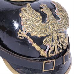 WWI Prussian M1895 Pickelhaube, the black leather skull with brass spike finial, brass eagle helmet plate and leather chin strap, one side with a black cockade,  the other black and red, with leather lining